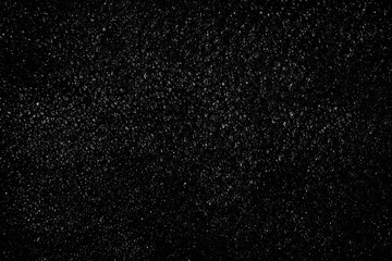 Falling snow on a black background. small particles with bright dots starry sky. Сhaotic white bokeh. light spots texture. abstract.