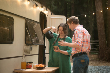 couple in love in front of caravan trailer having dinner