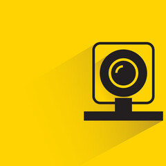 video camera with shadow on yellow background