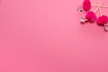 pink party toothpicks in a shape of flamingo on a pink background. origami 