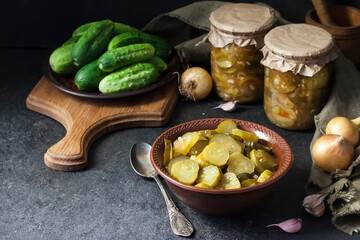 Pickled cucumber salad in a bowl and jars