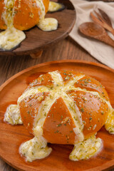 Korean Garlic bread consists of bread topped with garlic and olive oil or butter and may include additional herbs, such as oregano or chives. It is then either grilled in bread oven.