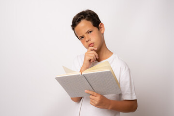 Happy thoughtful male student holding book isolated on a white background