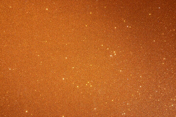 Orange texture with sparkles and and a shadow from the top right corner. Sparkling stars effect...