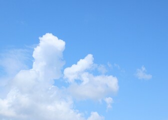 Naklejka na ściany i meble white cloud in the form of a man on a horse against a blue sky, abstraction