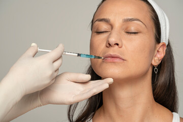 young satisfied woman on a lip filler injection procedure