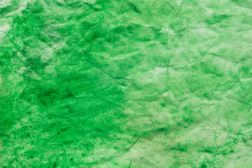 green watercolor painted texture on creased paper