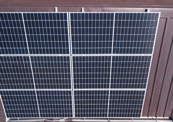 A Polycrystalline Solar panel system mounted on a ribbed metal roofing of a house.