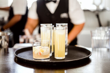 Alcoholic and non alcoholic beverages on a tray in the bar