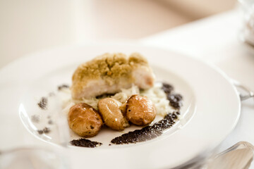 Traditional Portuguese baked cod served with baked potato