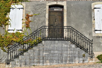 Facade of ancient house with an old double staircase.