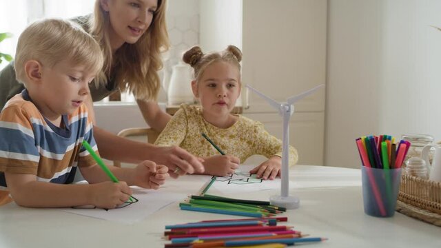 Video of children coloring a recycle symbol. Shot with RED helium camera in 8K