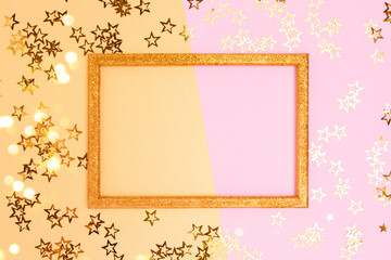 Glittering empty frame with stars confetti. Festive concept with copy space on a pink and gold background.