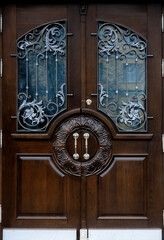Wooden door with metal ornament 