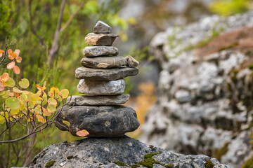 Balance stones on the rock in autumn forest