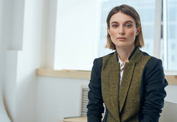 woman sitting near the window office work professionals