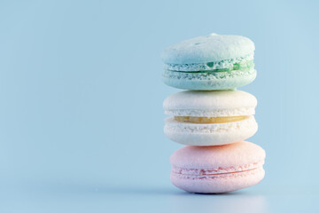Sweet french macaroons cake pastel colored or macarons with vintage pastel blue colored background