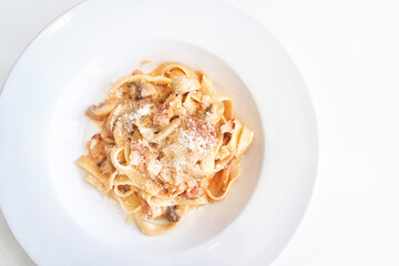 Plate with alfredo pasta. Cooking uhealthy lunch. Salty spicy carbonara. Parmesan cheese. Delicious italy bowl. Fettuccine noodles