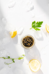 Appetizers of natural sturgeon black caviar, lemon and parsley