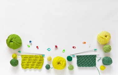 Beautiful composition of balls and skeins of green and yellow yarn for hand knitting, accessories...