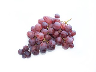 a bunch of ripe grapes on a white background