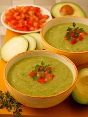 Zucchini and avocado soup. With tomato and parsley.