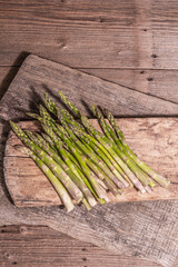 Ripe asparagus ready for cooking on vintage wooden stands © FuzullHanum