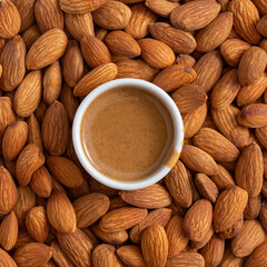 Almond butter smooth, urbech. Natural paste from almond nuts. Top view, close-up, food background.