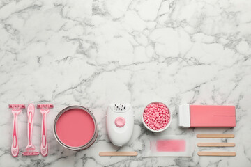 Set of epilation products on white marble table, flat lay. Space for text