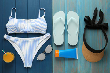 Flat lay composition with beach objects on blue wooden background