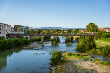 Fototapeta premium Carcassonne, France. View of river Aude and a modern bridge with cars and pedestrians.
