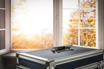 Suitcase for photographic equipment in the landscape of autumn surroundings, before the trip 