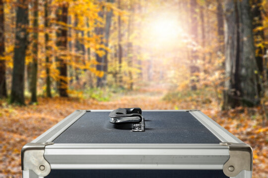 Suitcase for photographic equipment in the landscape of autumn surroundings, before the trip 