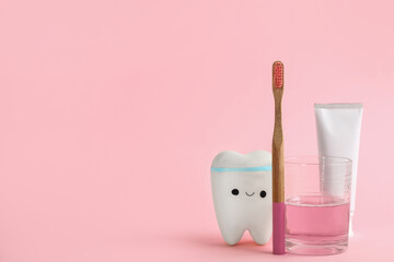 Mouthwash, toothbrush, paste and holder on pink background. Space for text