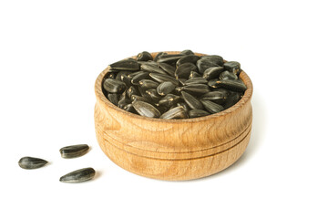 Sunflower seeds in wooden bowl isolated on white background.