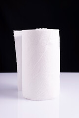 roll of white paper towels napkins on white table