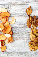 Border of a pile of dried pears and apples in slices on a white wooden background. Dried fruit chips. Healthy food