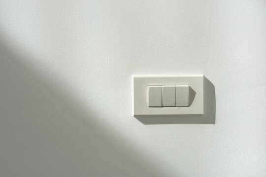 White switch power on a white wall