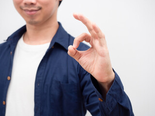 Fototapeta premium Closeup hand ok of asian man smile face portrait white background