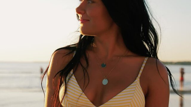 people, summer and swimwear concept - happy smiling young woman in bikini swimsuit walking on beach