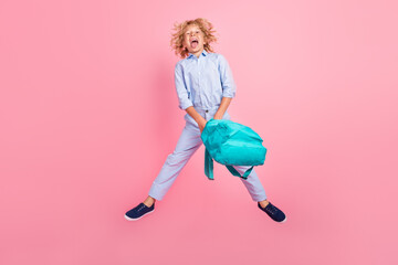 Full size photo of young carefree smiling rude childish boy jumping show tongue isolated on pink...