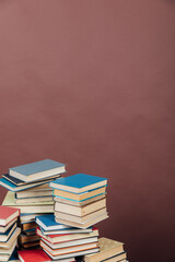Stacks of books for teaching knowledge university library brown background