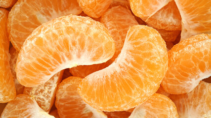 Heap of peeled tangerine segment fruit, Mandarin pieces vitamin C healthy organic fruit, Top view,...