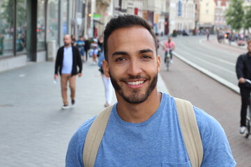 Young ethnic adult walking on the street