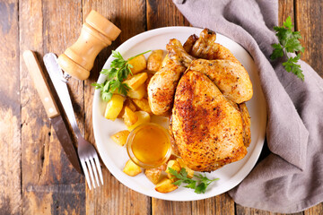 roasted chicken with sauce and potatoes