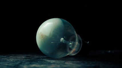 A transparent light bulb on black background
