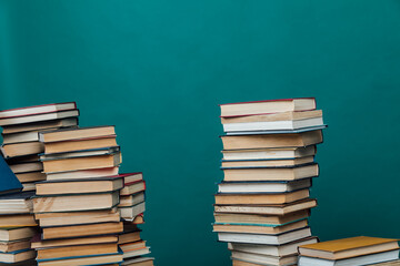 stacks of books for teaching knowledge of the university library green background
