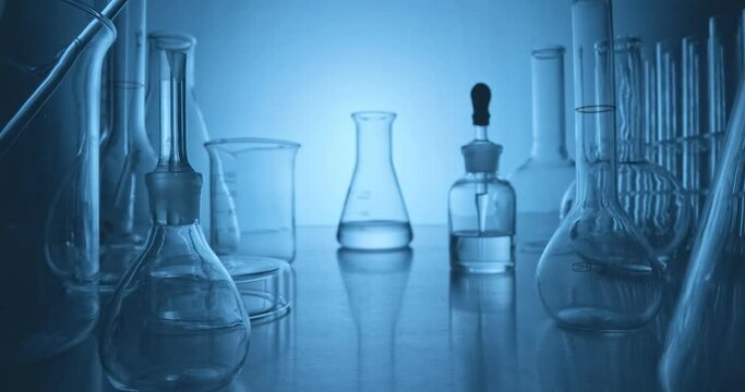 Scientist analyzing a sample in an erlenmeyer in the laboratory