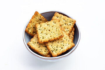 Seaweed crackers in bowl on white background.