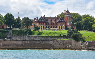 Fototapeta premium San Sebastian, Spain - 2 August 2021: Miramar Palace and Ondaretta Beach from La Concha Bay